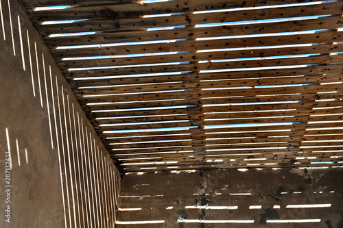 Textural striped shadows on the walls of the house.