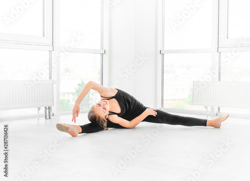 Teen girl making ballet stretches