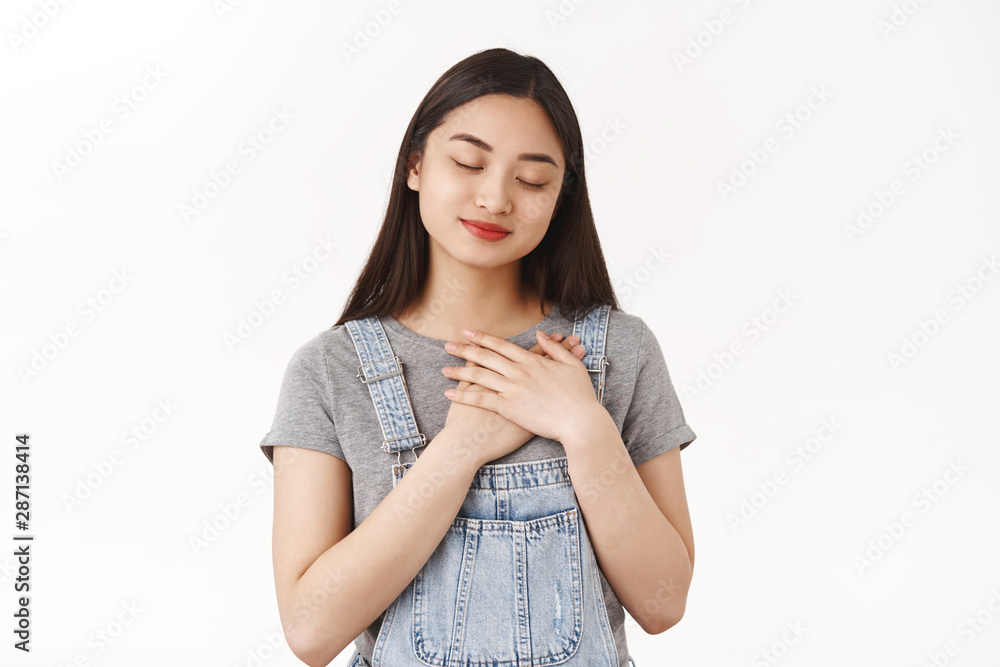 Tender caring lovely romantic asian young girl thinking lover close eyes imaging cherish memory smiling delighted hold hands heart express sympathy tenderness deep sincere feelings Tender caring lovely romantic asian young girl thinking lover close eyes imaging cherish memory smiling delighted hold hands heart express sympathy tenderness deep sincere feelings