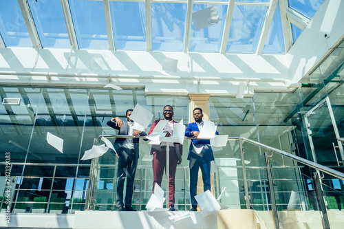 mixed race business people sitting in modern office copy space