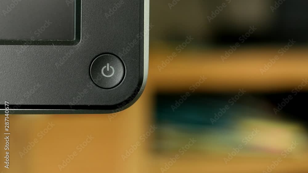 Turning on and off computer monitor on desk with finger