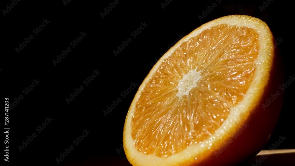 Orange isolated on a black background. Citrus fruit. Fresh and Ripe halved oranges rotating Orange isolated on a black background. Citrus fruit. Fresh and Ripe halved oranges rotating