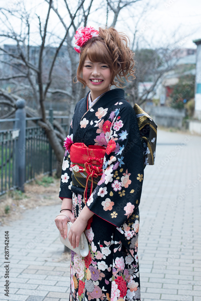 Japanese girl posing for the pictures of the Coming of Age Day. In Japan, people celebrate their 20s of a year as becoming adults wearing Japanese tradition dress. Japanese girl posing for the pictures of the Coming of Age Day. In Japan, people celebrate their 20s of a year as becoming adults wearing Japanese tradition dress.