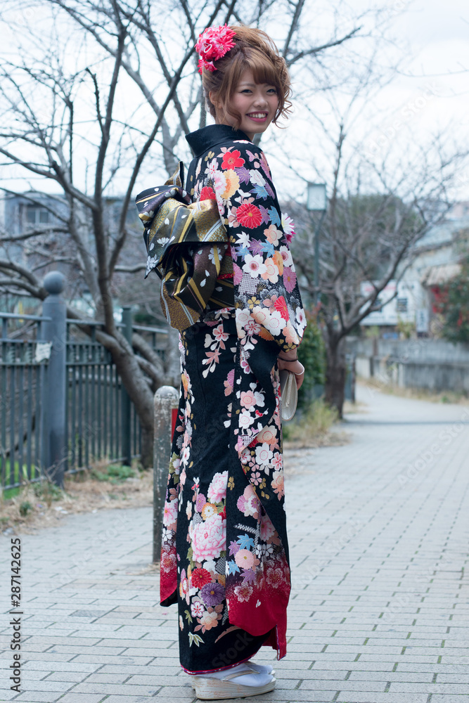 Japanese girl posing for the pictures of the Coming of Age Day. In Japan, people celebrate their 20s of a year as becoming adults wearing Japanese tradition dress. Japanese girl posing for the pictures of the Coming of Age Day. In Japan, people celebrate their 20s of a year as becoming adults wearing Japanese tradition dress.