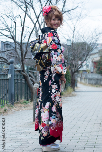 Japanese girl posing for the pictures of the Coming of Age Day. In Japan, people celebrate their 20s of a year as becoming adults wearing Japanese tradition dress.