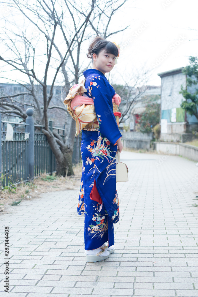 Japanese girl posing for the pictures of the Coming of Age Day. In Japan, people celebrate their 20s of a year as becoming adults wearing Japanese tradition dress. Japanese girl posing for the pictures of the Coming of Age Day. In Japan, people celebrate their 20s of a year as becoming adults wearing Japanese tradition dress.