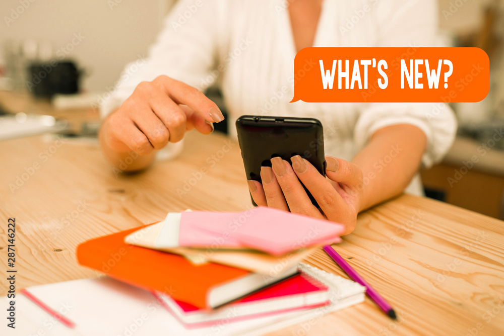 Word writing text What S New Question. Business photo showcasing when you ask someone about his current live events actions woman using smartphone office supplies technological devices inside home Word writing text What S New Question. Business photo showcasing when you ask someone about his current live events actions woman using smartphone office supplies technological devices inside home