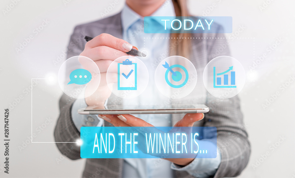 Handwriting text And The Winner Is. Conceptual photo announcing a demonstrating or thing that wins something Female human wear formal work suit presenting presentation use smart device Handwriting text And The Winner Is. Conceptual photo announcing a demonstrating or thing that wins something Female human wear formal work suit presenting presentation use smart device