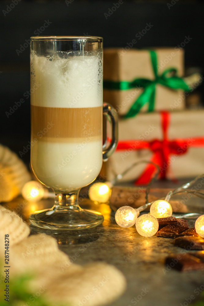 Coffee with milk and gifts on the table - festive atmosphere, (latte) New Year and Christmas. top food background. copy space Coffee with milk and gifts on the table - festive atmosphere, (latte) New Year and Christmas. top food background. copy space