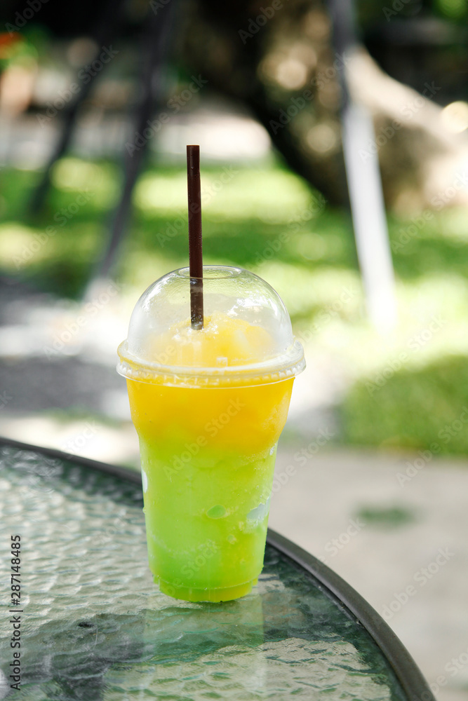 Mango and melon smoothie in a plastic cup at cafe Mango and melon smoothie in a plastic cup at cafe
