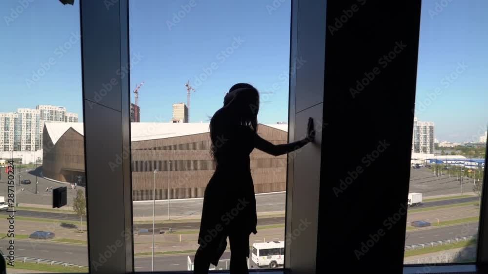 Professional dancer dancing at the window. plastic and gentle movement in the shade. Professional dancer dancing at the window. plastic and gentle movement in the shade.
