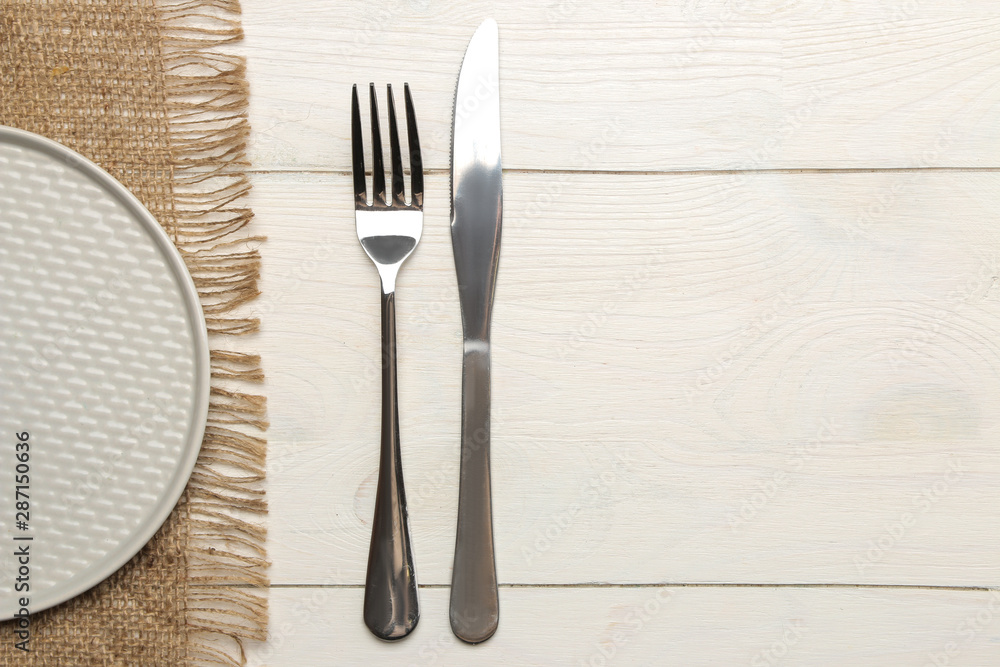 table setting. cutlery. Fork, knife and gray plate on a white wooden table. top view table setting. cutlery. Fork, knife and gray plate on a white wooden table. top view