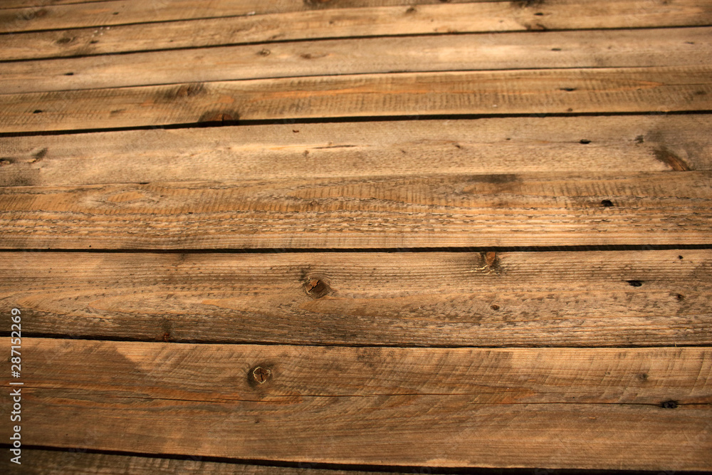 Dark rustic brown wood uneven planks background Dark rustic brown wood uneven planks background