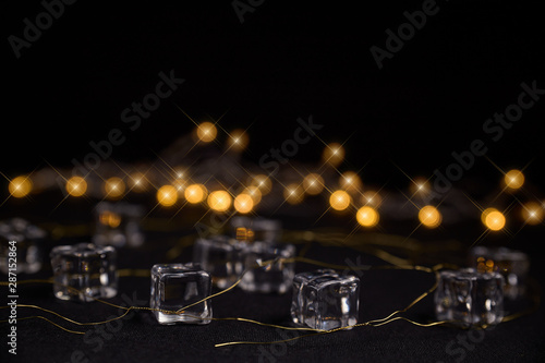 ice cubes with a party lights background