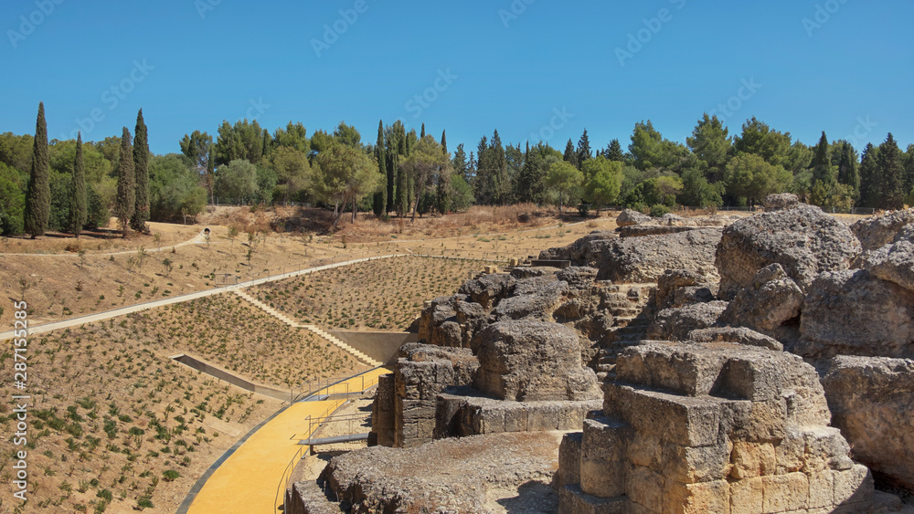 Land and ruins of the amphitheater, part of archaeological ensemble of Italica, city with a strategic role in the Roman Empire, birthplace of Emperors Trajan and Hadrian, in Santiponce, Seville, Spain