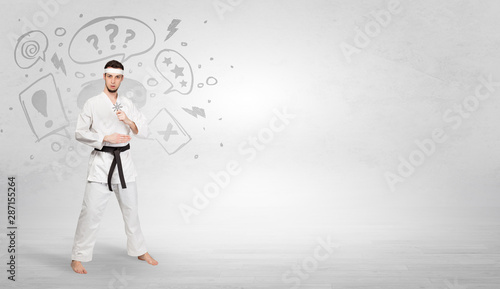 Young kung-fu trainer fighting with doodled symbols concept
