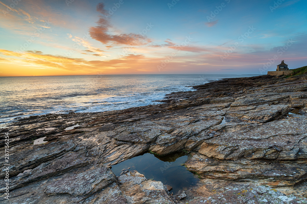 Sunrise over the rocky shore at Howick