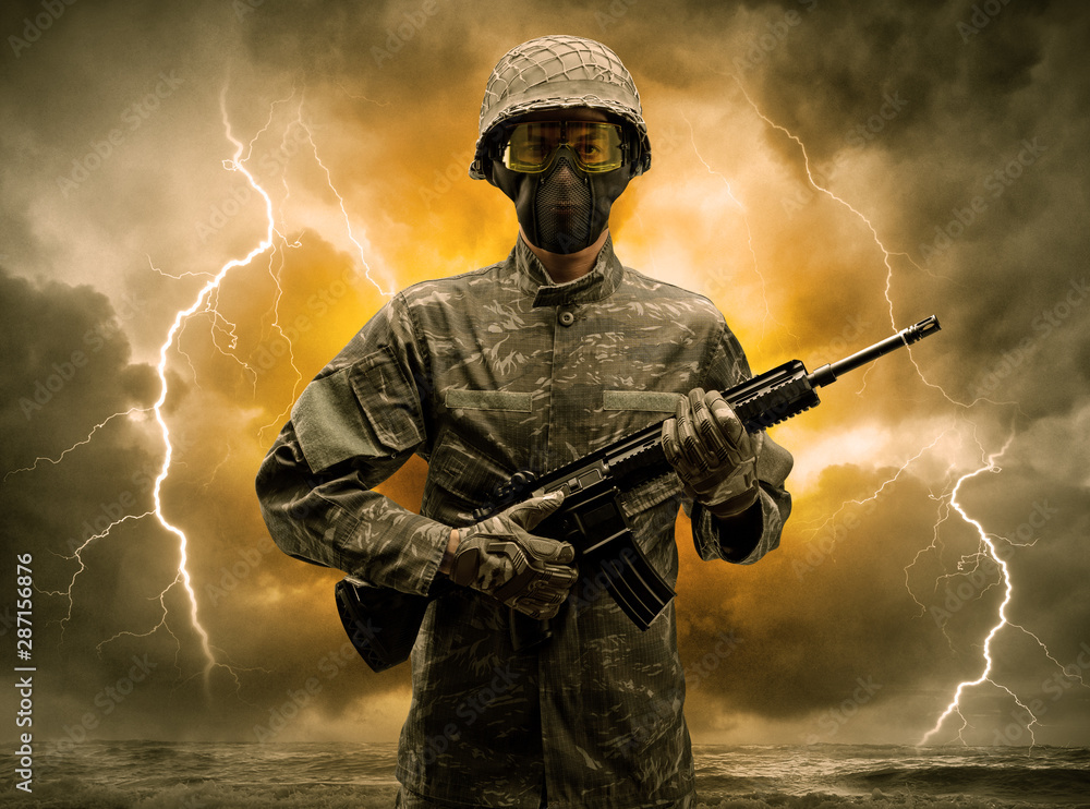 Armed soldier standing in rainy obscure weather