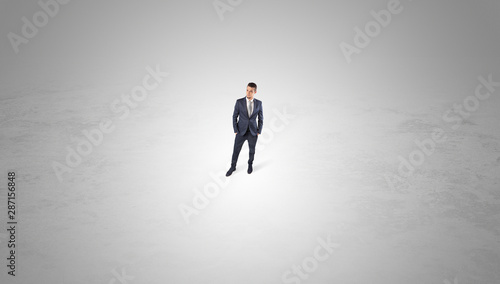 Young businessman standing alone in the middle of an empty space