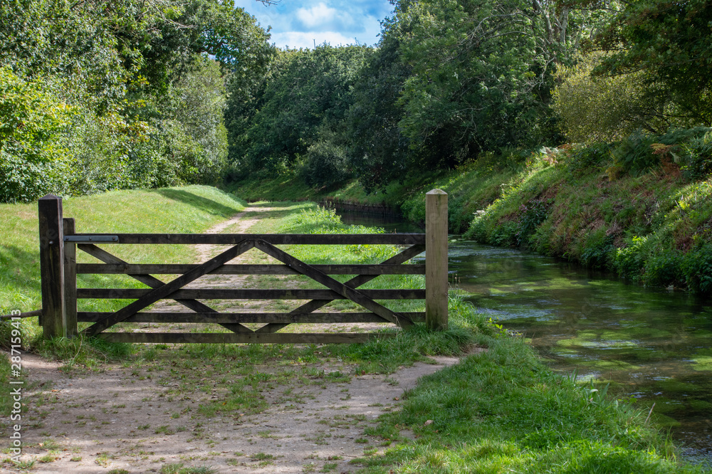 Gate alongside a river footpath Gate alongside a river footpath