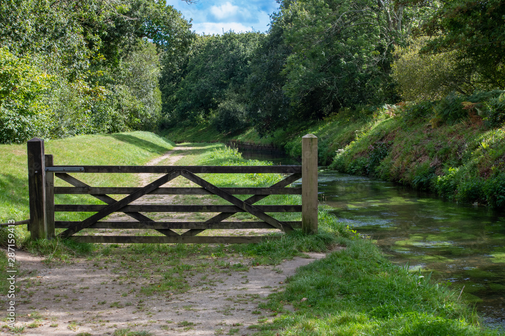 Gate alongside a river footpath