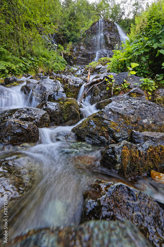 Waterfall among the rocks on the path to L Oursiere  in Chamrousse massif