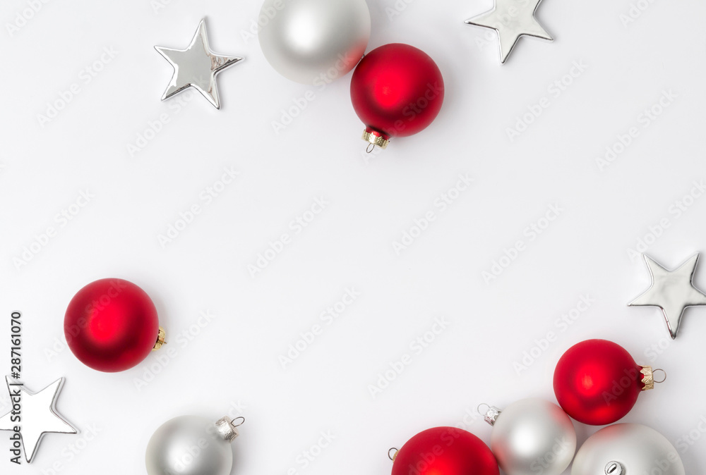 Red and white matte Christmas stars and balls decoration on white background with copy space - obrazy, fototapety, plakaty 