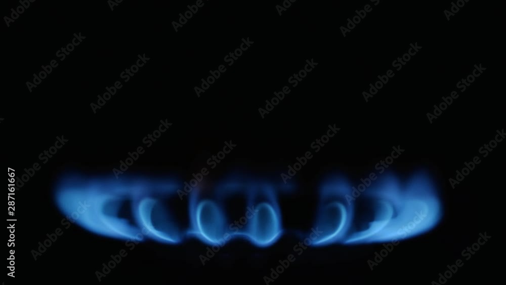 Kitchen burner turning on.Stove side burner igniting into a blue cooking flame. Natural gas inflammation, close up. Kitchen burner turning on.Stove side burner igniting into a blue cooking flame. Natural gas inflammation, close up.