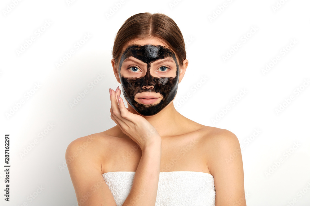 pleasant young woman applying a mask on her face, close up portrait, isolated white background, studio shot, pleasant young woman applying a mask on her face, close up portrait, isolated white background, studio shot,