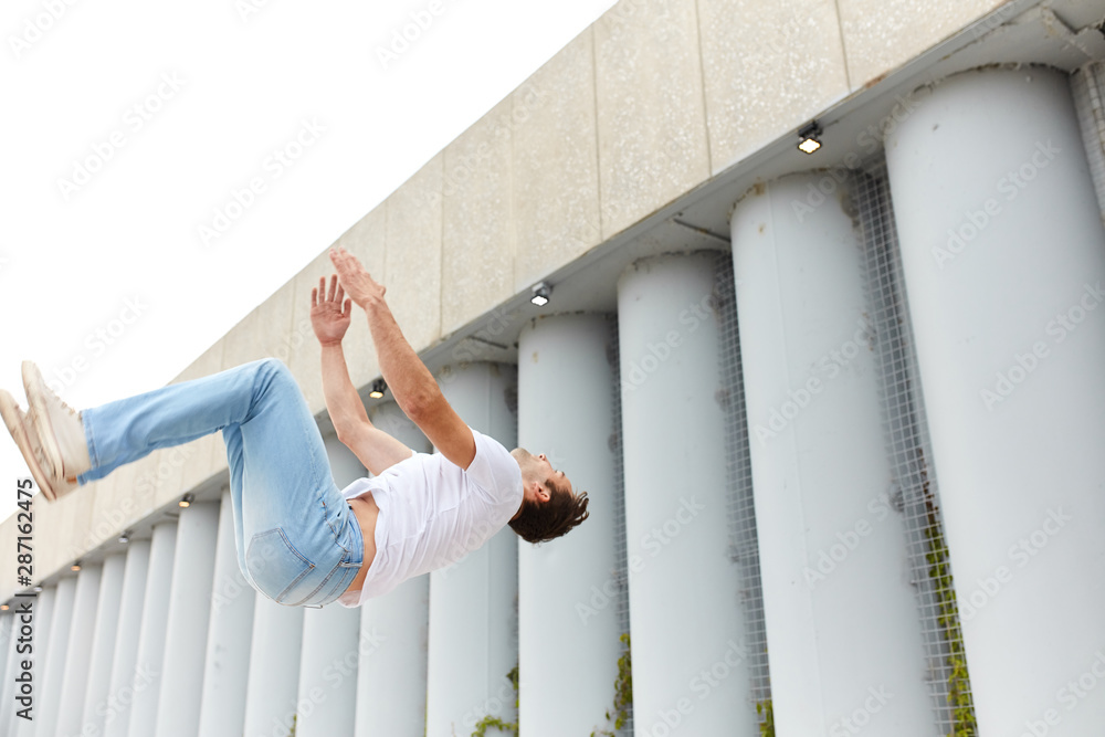 young man jumping from high object. extraodinary kind of sport. full length side view photo, exotic sport , copy space