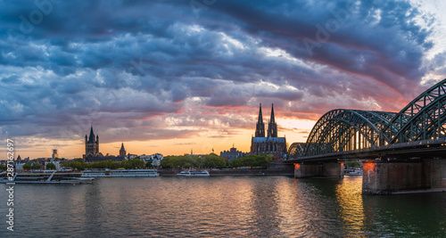 Cologne bridge with sunset and clouds
