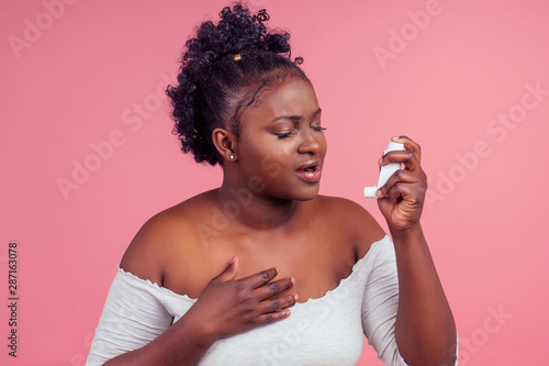 African american woman over isolated pink background feeling unwell and coughing as symptom for cold or bronchitis
