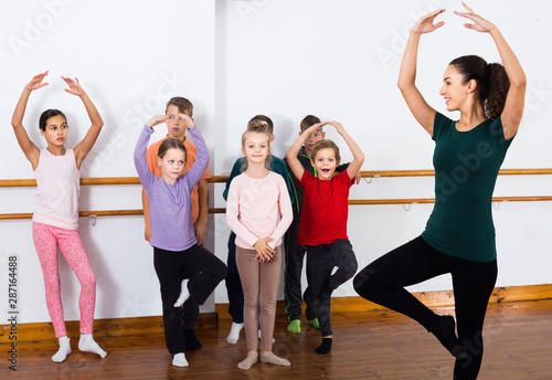 Group of children practicing at the ballet barre