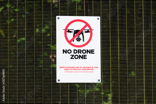 No drone zone sign not allowing flying of quadcopter at military police site near airport photo