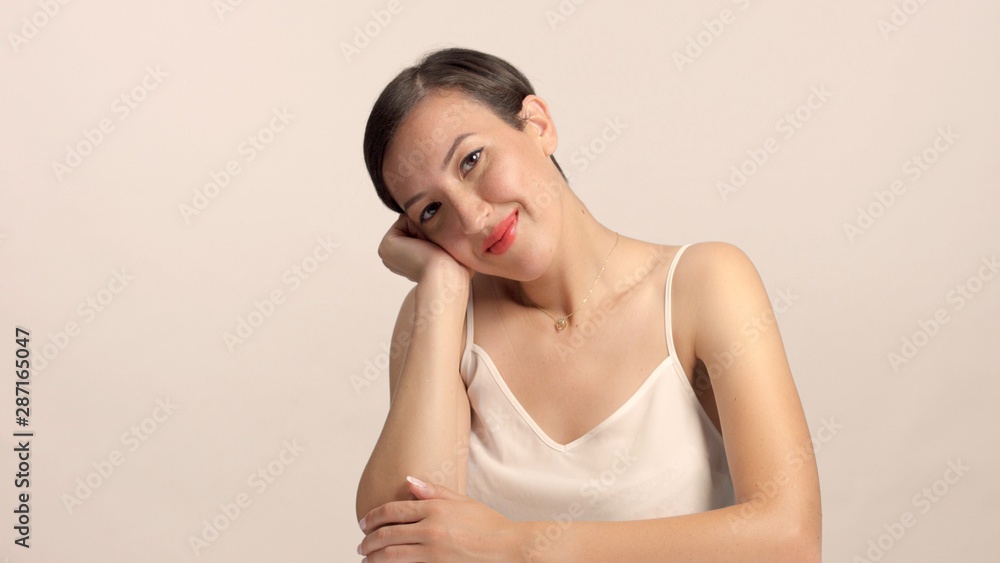 beauty brunette with short haircut model in studio alone with ideal shiny skin in position looks boed, but smiling beauty brunette with short haircut model in studio alone with ideal shiny skin in position looks boed, but smiling