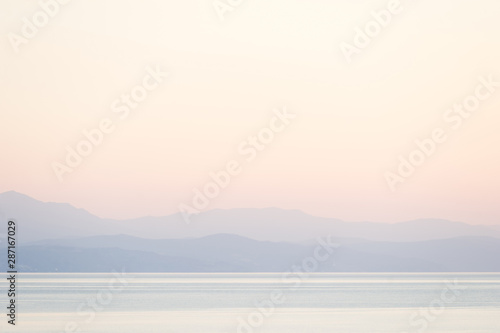 Mountain view on the horizon in light fog over the Black Sea at sunrise