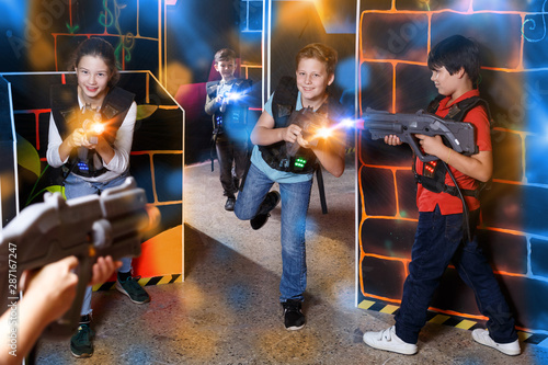 Glad teens aiming laser guns at other players © JackF