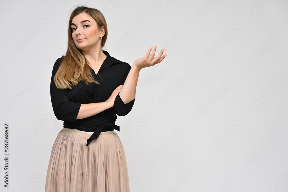 Portrait of a cute middle-aged manager brunette woman with beautiful curly hair and perfect face skin in a business suit on a white background. Beauty, brightness, smile. Portrait of a cute middle-aged manager brunette woman with beautiful curly hair and perfect face skin in a business suit on a white background. Beauty, brightness, smile.