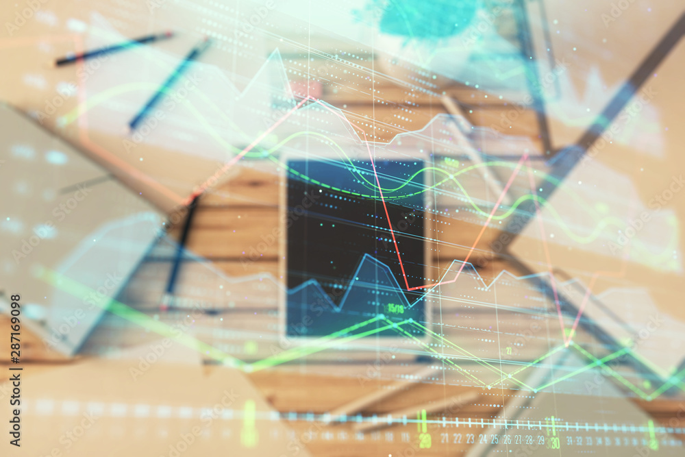 Double exposure of forex graph on digital tablet laying on table background. Concept of market analysis Double exposure of forex graph on digital tablet laying on table background. Concept of market analysis