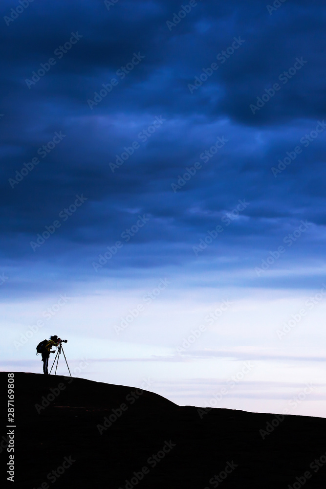 Male photographer on the mountain peak.