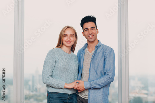 Happy young couple. Positive man and woman portrait. Hug and happy.