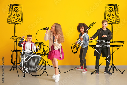 Billede på lærred Teenage musicians with drawing instruments playing against color wall