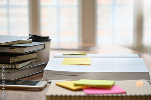 Education concept, notebook, book with sticky note on wood table.