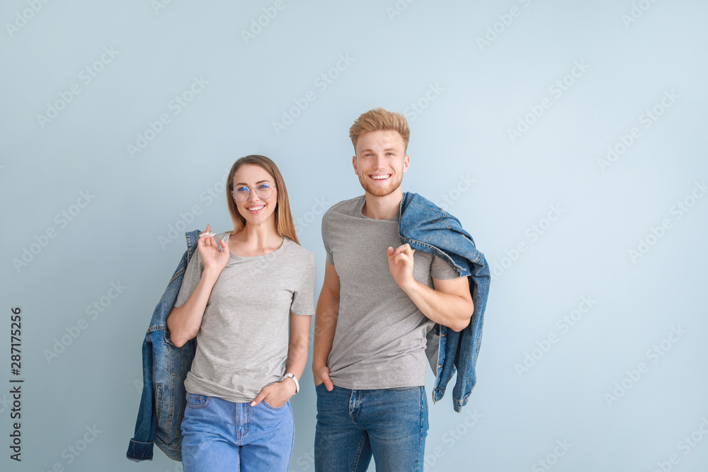 Couple in stylish t-shirts on color background Couple in stylish t-shirts on color background
