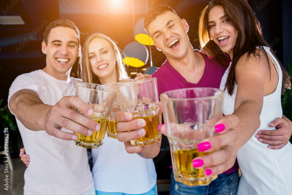 Cheerful friends in the pub. Drinking beer, talking, having fun. Cheerful friends in the pub. Drinking beer, talking, having fun.