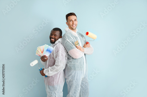 Male painters near color wall