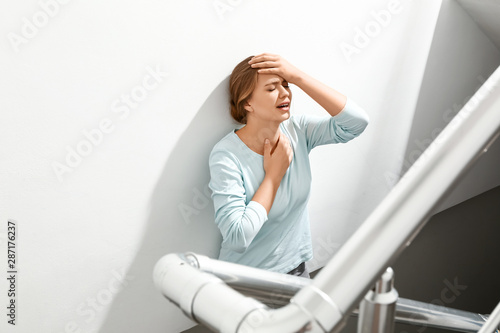 Woman having panic attack in the stairway