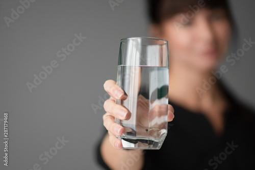 woman holds a glass of water in her hands. Office. Businessman. Close-up