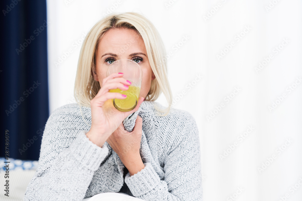 Adult woman feeling unewll and taking medicine at home Adult woman feeling unewll and taking medicine at home