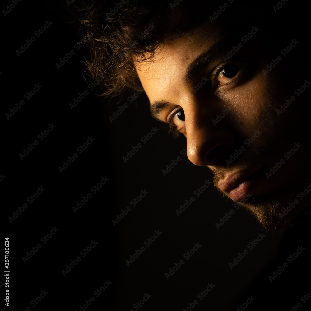 Shadows portrait looking camera sad Shadows portrait looking camera sad